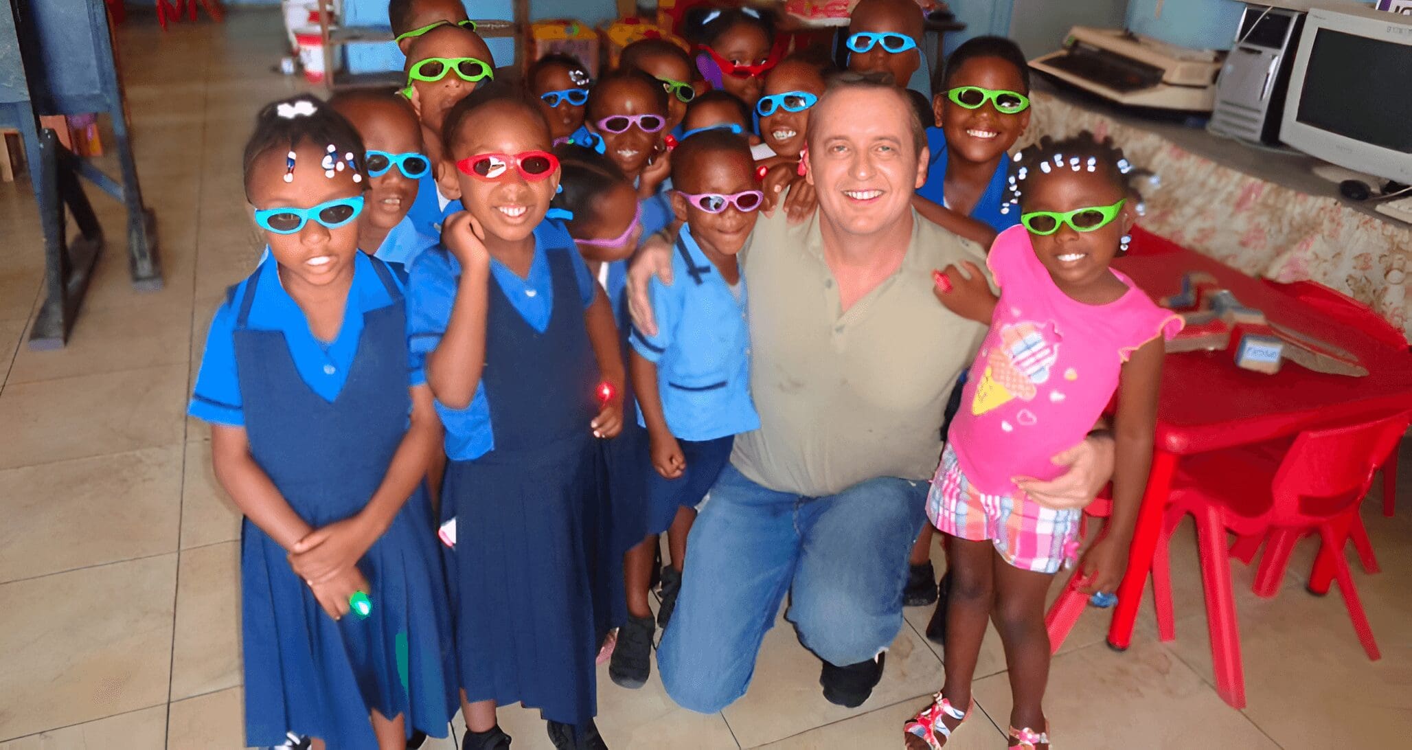 Man with children wearing colorful glasses.