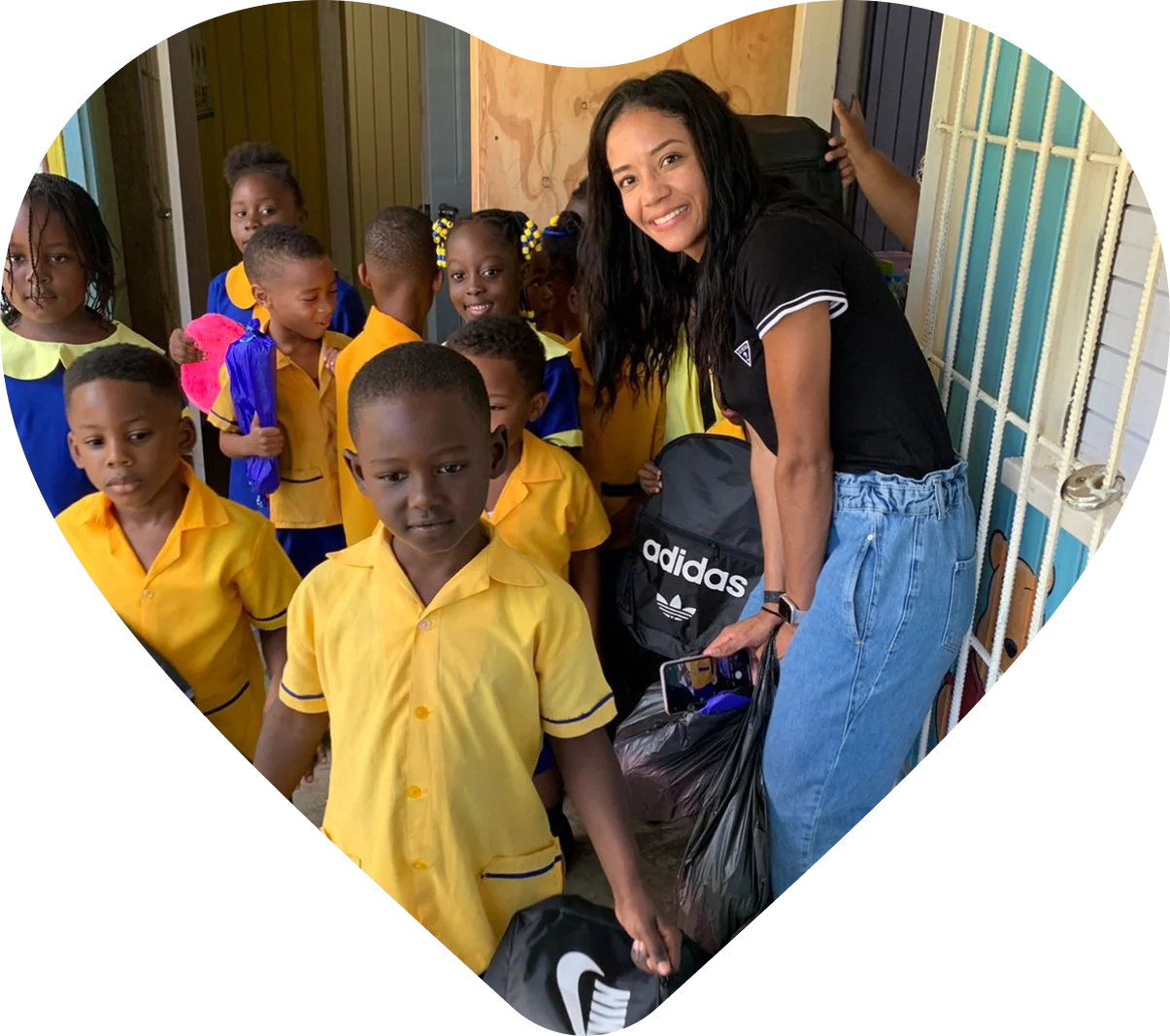 A woman standing next to a group of children.